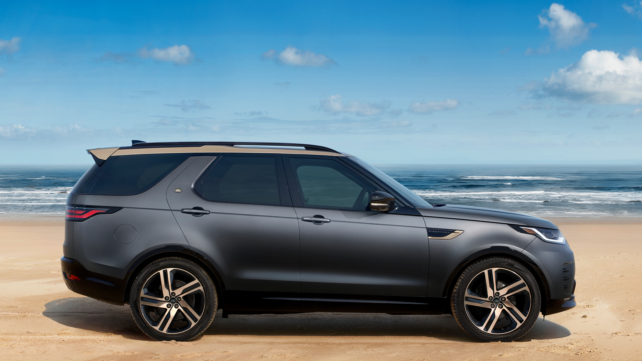 Discovery parked on seashore side view