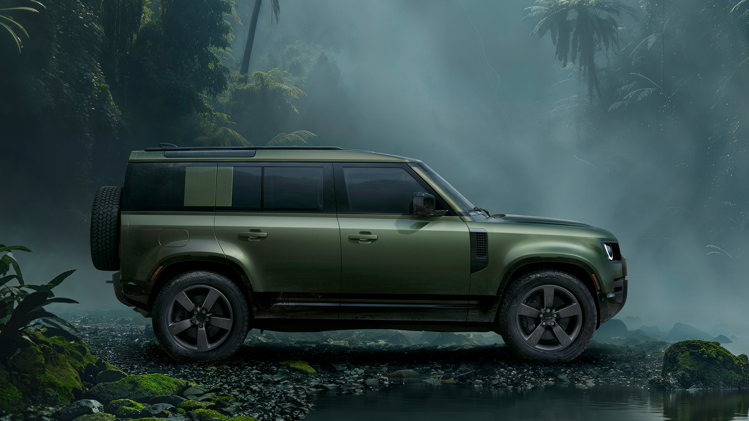 Defender side view parked in forest