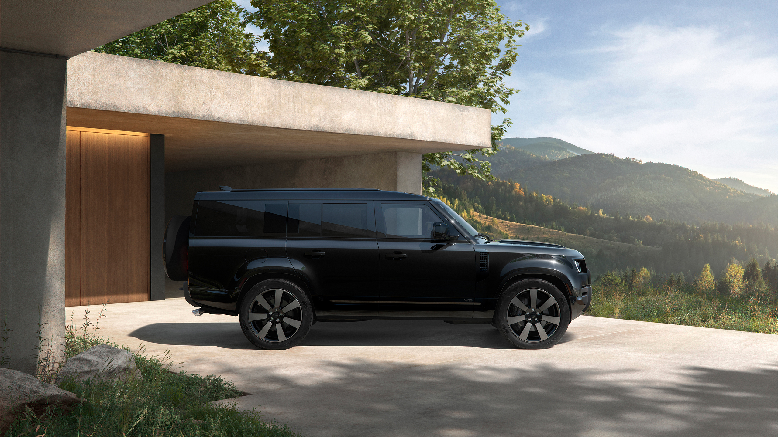 Side view of a matte black Defender.